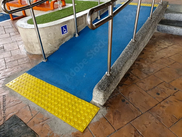Obraz Concret ramp way with stainless steel handrail with disabled sign for support wheelchair disabled people.