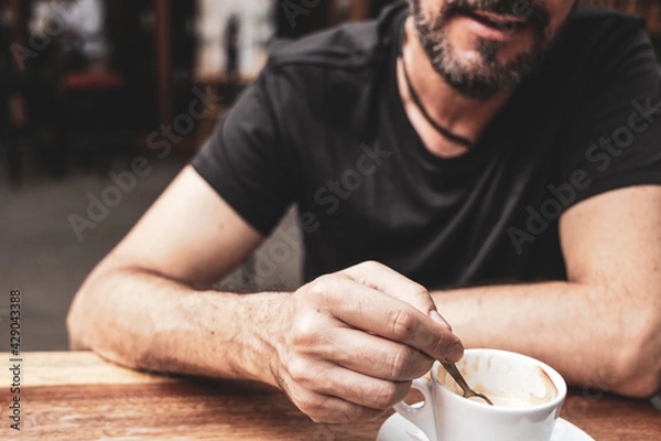 Obraz Bearded man is drinking coffee; close up, selective focus.