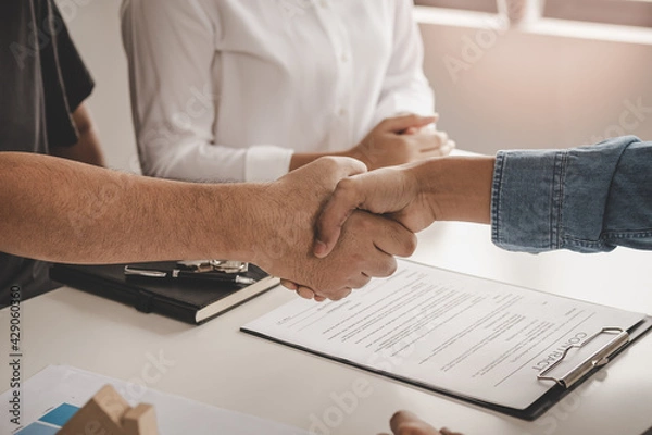 Fototapeta Close up hand of home, apartment agent or realtor handshake with newlandlord, tenant or rental. After the banker has approved and signed the purchase contract agreement successfully. Property concept.