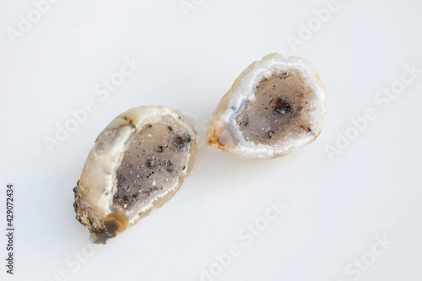 Obraz Druse of natural mineral agate. Closeup photo. Couple of beige crystals with black small inclusions.