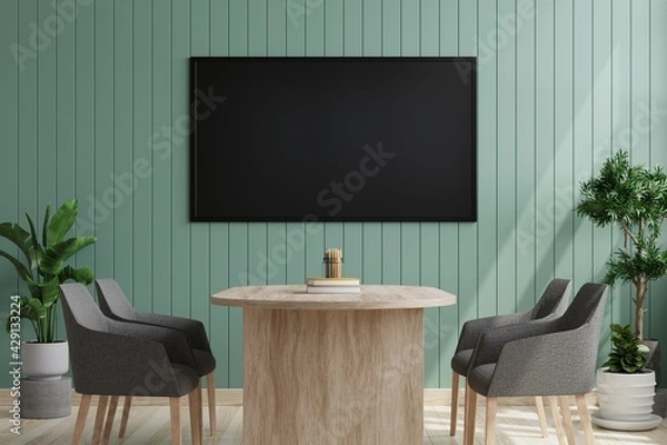Fototapeta TV on the green wooden wall in the meeting room There is an armchair and a desk set on the front wooden floor and decorated with plant pots on the side.3d rendering.