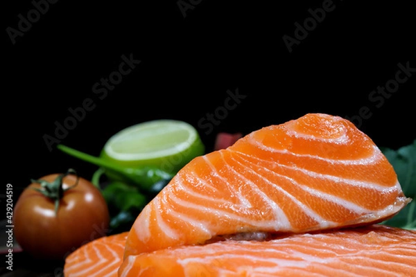 Obraz Fresh salmon with spices  on the table, garlic, tomato and lemon