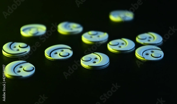 Fototapeta plastic buttons on black surface