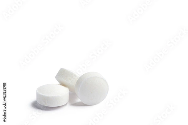 Fototapeta White round pills isolated on a white background with clipping path. A heap of small round meds. Health care and medicine concept
