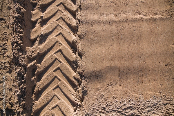 Obraz sand with tractor wheel tread on it