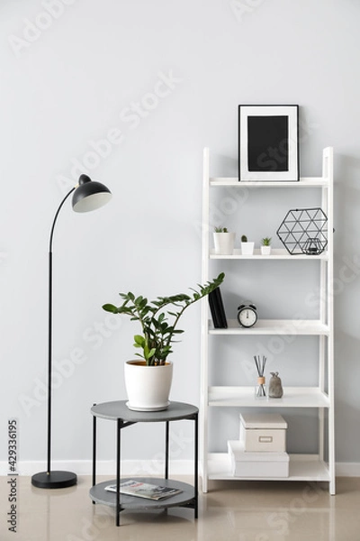 Fototapeta Interior of modern room with shelf unit and lamp