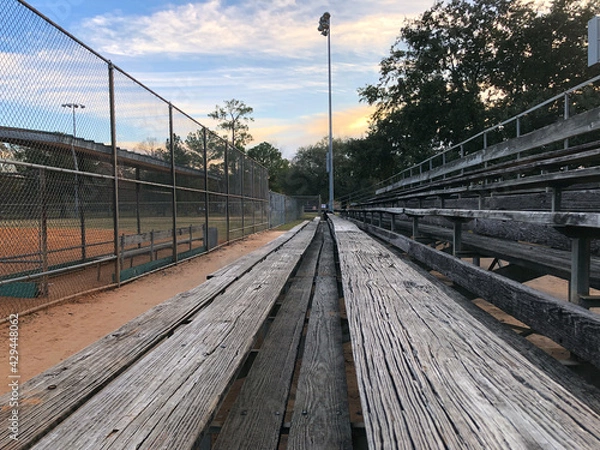 Fototapeta Empty bleachers on a baseball field 
