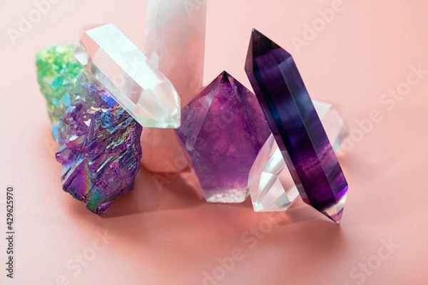 Obraz Various crystals for healing and magical practices. Faceted amethyst, rose quartz, fluorite, rock crystal, a cluster of quartz on a pastel pink background