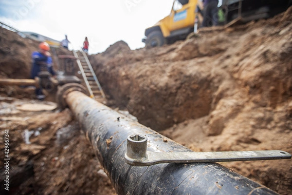 Fototapeta emergency services, the repair team provides safety during the replacement of pipes, old communications are changed to new ones, the gas pipeline, the old and rusted water pipe with dirty gates, repla