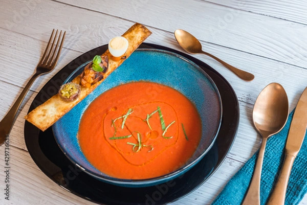 Obraz Tomato soup and a toast with quail egg and anchovy
