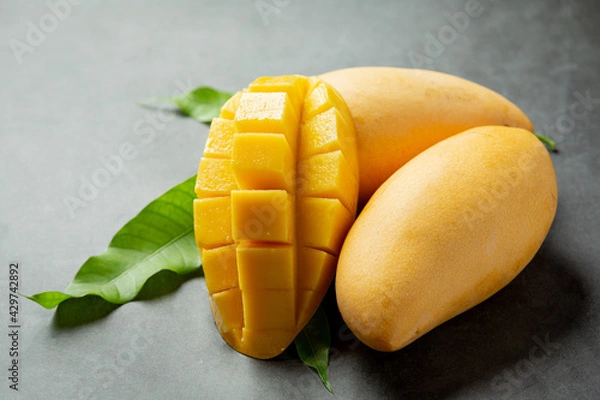 Obraz beautiful chopped ripe mango on dark wooden backgroud