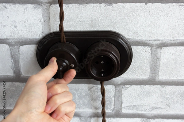 Obraz Hand switching a retro switch