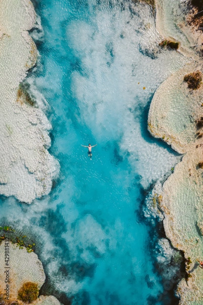 Fototapeta Boy swimming in Los rapidos de Bacalar cenote in Mexico