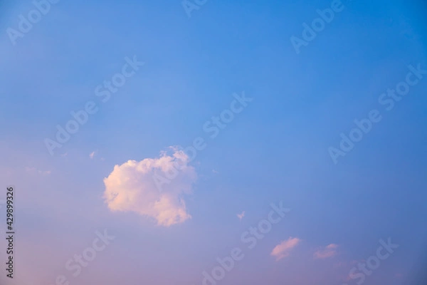 Fototapeta lonely soft clouds floating on blue sky,One white fluffy cloud floating in sky of blue in spring,Anime cloud image,A single puff of a cumulus cloud floats in the air,Cloud images of pink-blue tones.