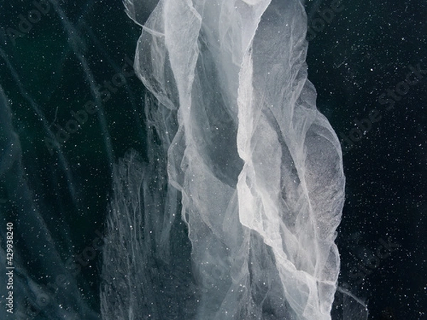 Fototapeta cracks in the ice of Lake Baikal. Natural patterns that never repeat. Winter in Siberia Russia