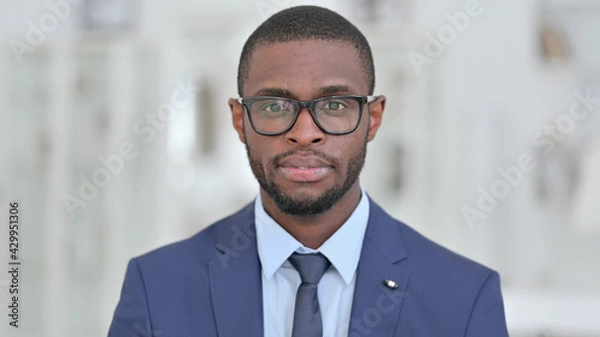 Obraz Portrait of Serious African Businessman Looking at the Camera