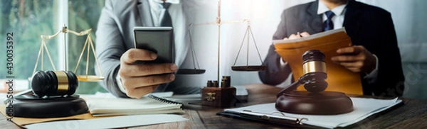 Fototapeta Business and lawyers discussing contract papers with brass scale on desk in office. Law, legal services, advice, justice and law concept
