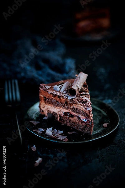 Obraz Plate with slice of tasty homemade chocolate cake on a dark background