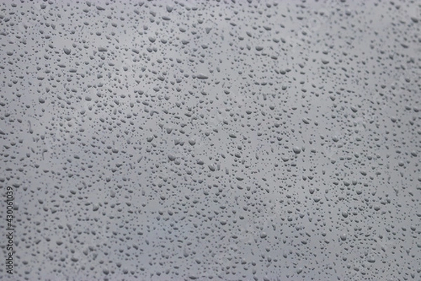 Fototapeta Stormy fall sky seen through window covered in drops