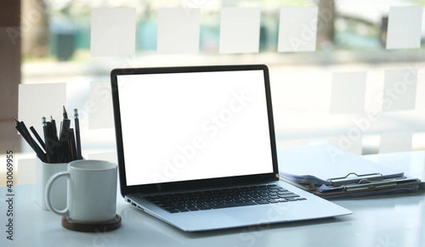 Fototapeta Modern workspace with computer with blank screen and equipment on white table.Blank screen for your information.