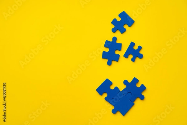 Obraz Blue puzzle pieces on paper background top view