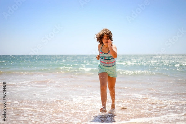 Fototapeta Girl running on the beach.