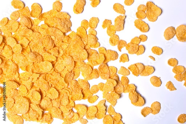 Fototapeta Cornflakes are scattered on a light background.