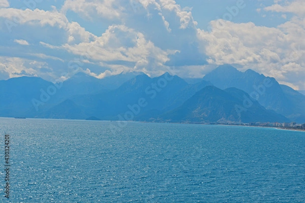 Obraz blue sky with clouds with mountains with sea 