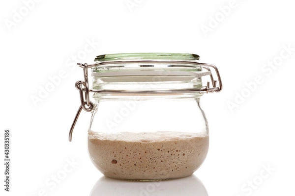 Obraz Active sourdough starter in a glass jar for homemade bread.