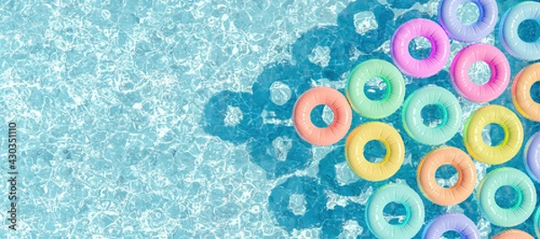 Fototapeta swimming pool seen from above with many rings floating
