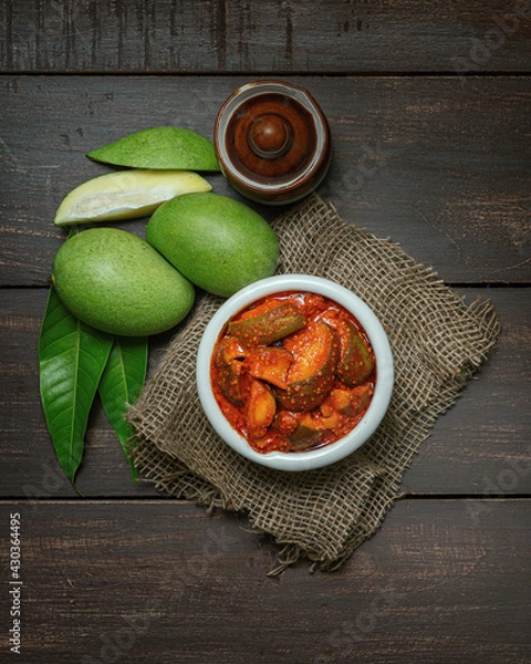 Fototapeta natural and homemade mango pickle or aam ka aachar on a rustic wooden background theme 