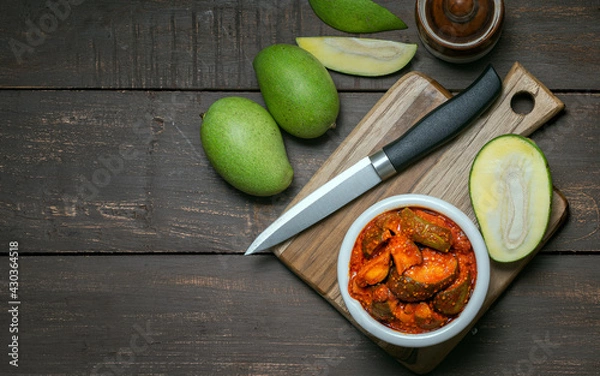 Fototapeta natural and homemade mango pickle or aam ka aachar on a rustic wooden background theme 