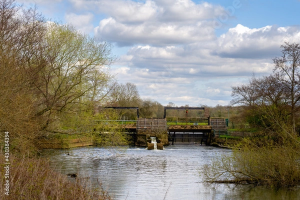 Fototapeta Sluice gate on the Ouse, walking on the Ouse way on a spring afternoon, Sussex, England