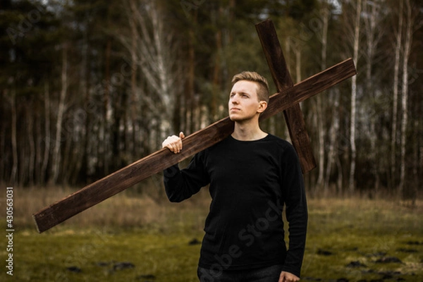 Obraz The man carries the cross. Сarry the cross. Man believes in God. Hope in God.