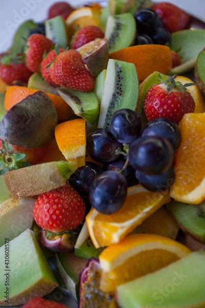 Fototapeta Fresh fruit salad, including sliced strawberries, blueberries, grapes, cantaloupe, and honeydew melon, for themes of health food, nutrition, freshness. High quality photo