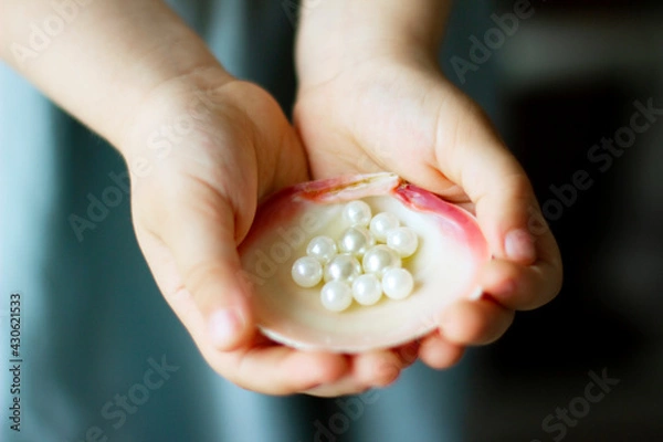 Obraz Children's hands hold oyster shell with pearls