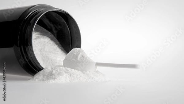 Obraz measuring spoon and white medicinal powder with black jar on white background