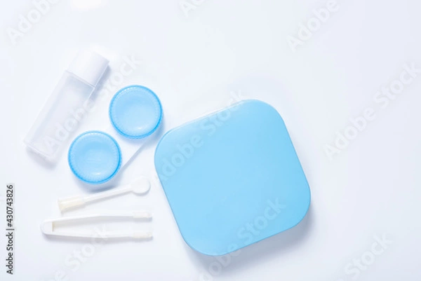 Obraz Soft contact lenses with solution, container and tweezers on white background with place for text. Macro photography