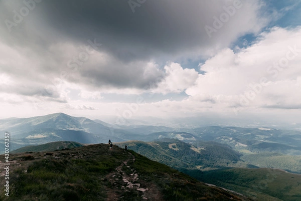 Fototapeta Tourist Group on the Mountain Trail Hike Backpacking