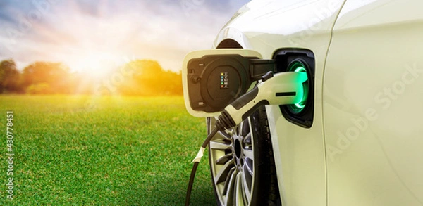 Fototapeta Power supply connect to electric car with nature background. Technology transport which are the future of the Automobile. Concept of reduce pollution, environment , Save the earth	