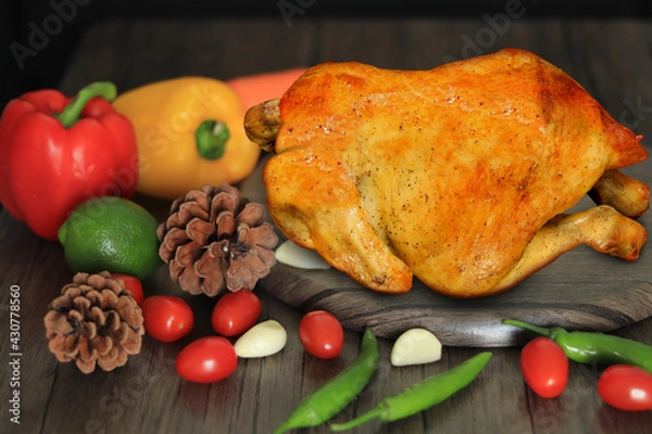 Obraz Roasted chicken with spices on wooden cutting board