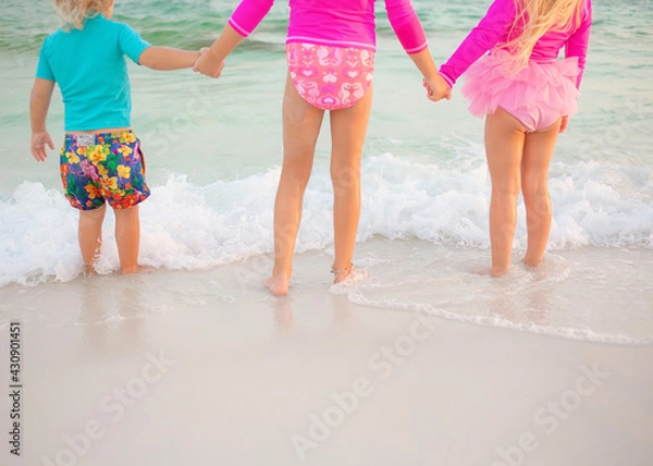 Obraz Family on beach at sunset with surfboard guitar