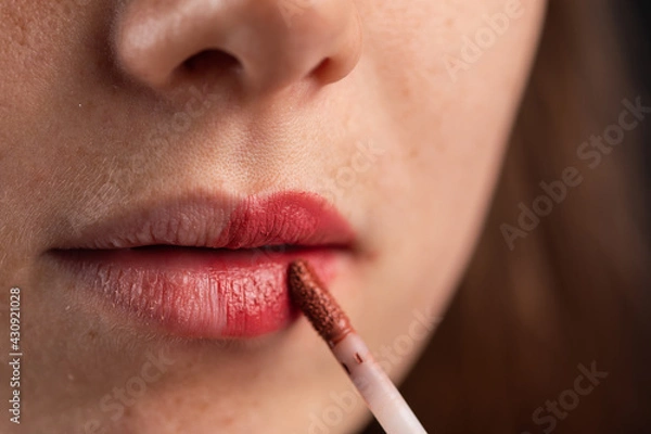 Obraz woman using a red lipstick