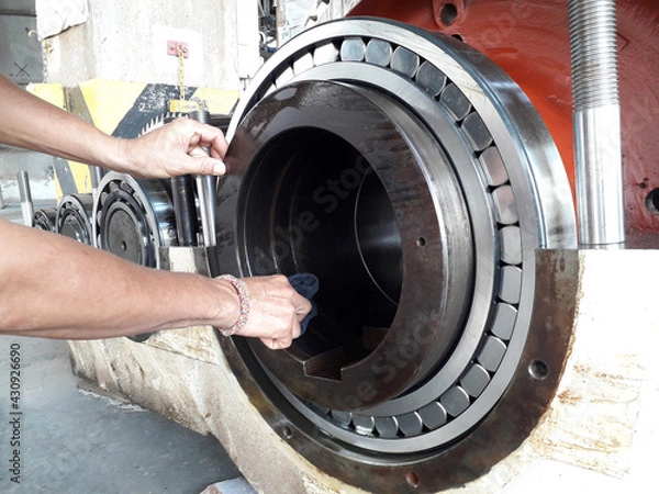 Fototapeta Large gears and cogs with bearing take out of machine to repair and clean the dirty trace of oil stain on shaft gear  bearings
