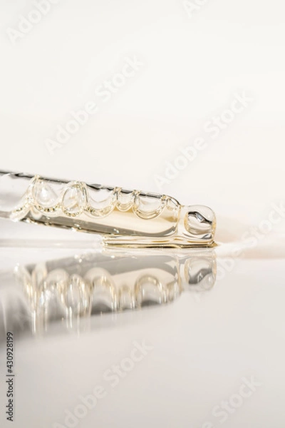 Fototapeta Cosmetic product in a pipette with bubbles.