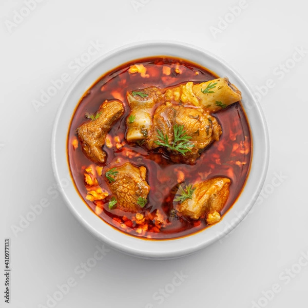 Fototapeta chicken or meat masala or curry in a white bowl on white background including red spicy gravy or curry 