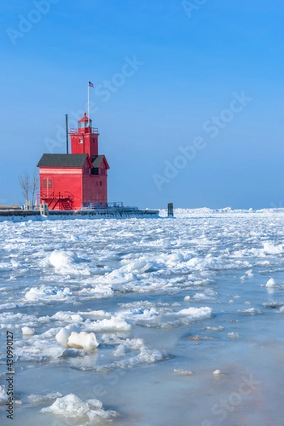 Fototapeta Big Red Lighthouse in Winter, frozen channel