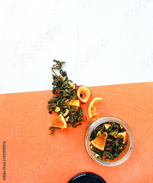 Fototapeta dried fruit in a jar and on the table. vegetarianism and healthy eating. energy for all time from healthy food. beautiful fruits in jars. weight loss. orange white glass. High quality photo