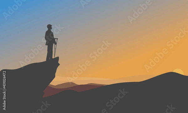 Fototapeta Self overcome as a businessman climbing mountain for reaching the finish flag.