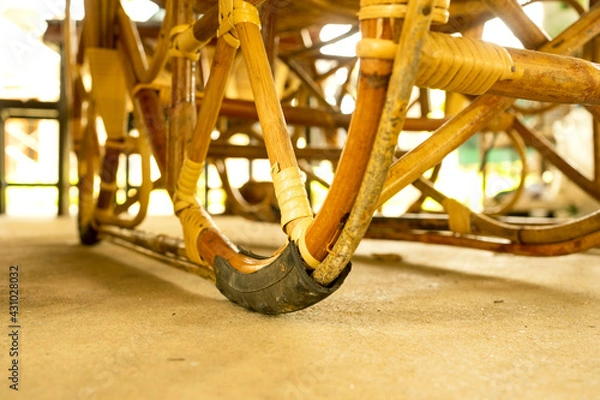 Fototapeta Old bicycle tires take advantage of the rattan bed legs to prevent wear and tear from use.